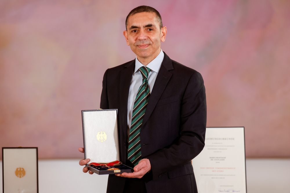 German scientist, CEO and co-founder of BioNTech, Ugur Sahin poses with the Bundesverdienstkreuz (Federal Cross of Merit) awarded to him by German President Frank-Walter Steinmeier, at the presidential Bellevue Palace in Berlin, Germany March 19, 2021 Odd