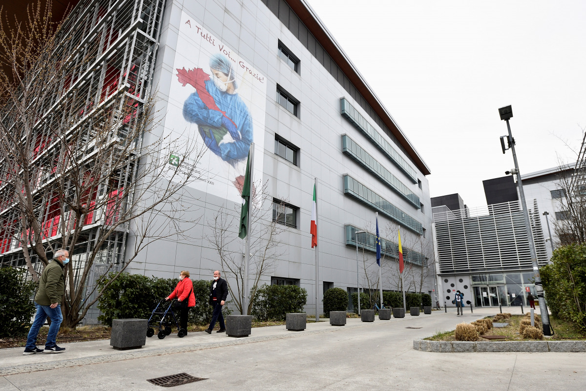 People wearing protective face masks are seen outside the Papa Giovanni XXIII hospital a year after the peak of Italy's coronavirus disease (COVID-19) outbreak, in Bergamo, the country's epicentre, Italy, March 3, 2021. Picture taken March 3, 2021. REUTER