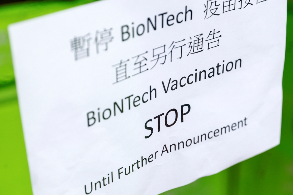 A sign is seen outside a vaccination centre after Hong Kong temporarily suspended coronavirus disease (COVID-19) vaccine from a single batch of Pfizer/BioNTech shots due to packaging defects, in Hong Kong, China March 24, 2021. REUTERS/Tyrone Siu