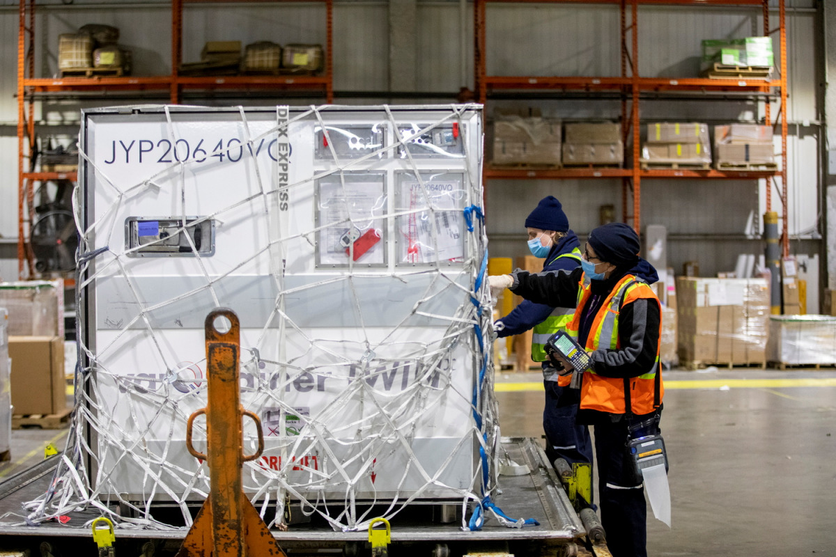 FedEx employees unload a shipment from Europe of the Moderna vaccine against the coronavirus disease (COVID-19) at Toronto Pearson Airport in Mississauga, Ontario, Canada March 24, 2021. REUTERS/Carlos Osorio
