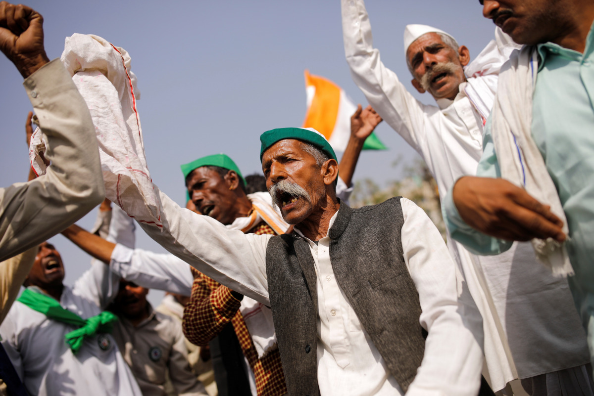 Farmers dance as they sing a folk song during a 12-hour strike, as part of protests against farm laws, on a highway at the Delhi-Uttar Pradesh border in Ghaziabad, India, March 26, 2021. REUTERS/Adnan Abidi
