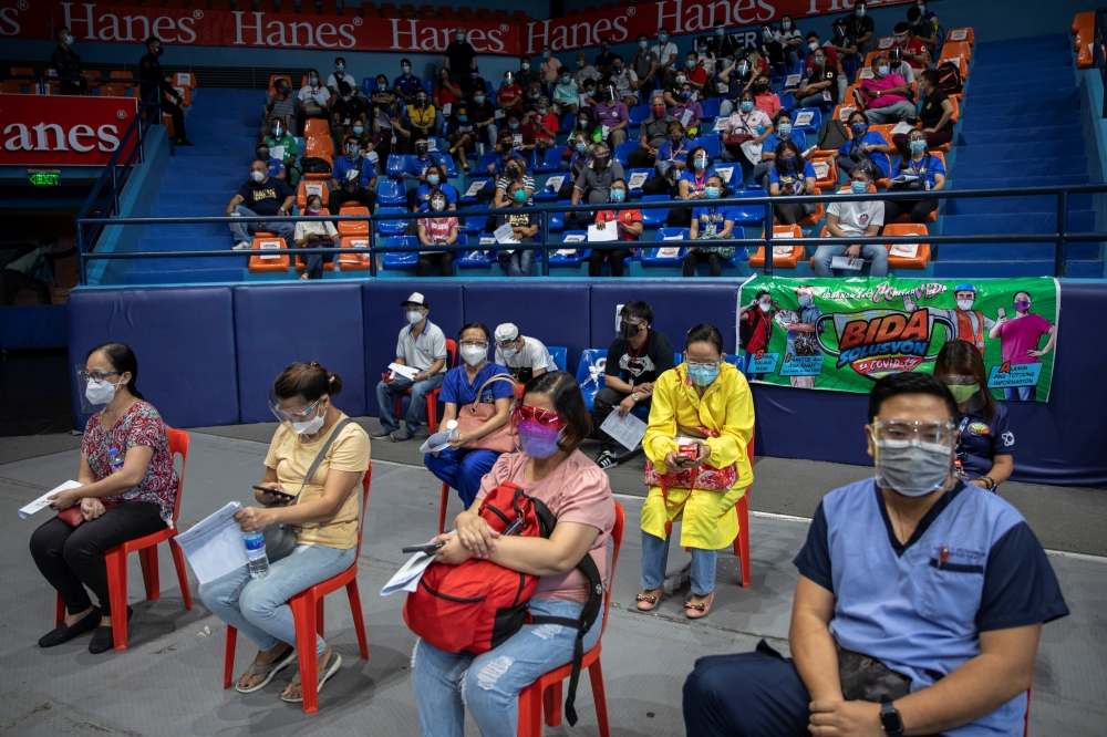 Healthcare workers and other essential workers queue to get coronavirus disease (COVID-19) vaccine at San Juan City, Metro Manila, Philippines, March 23, 2021. REUTERS/Eloisa Lopez