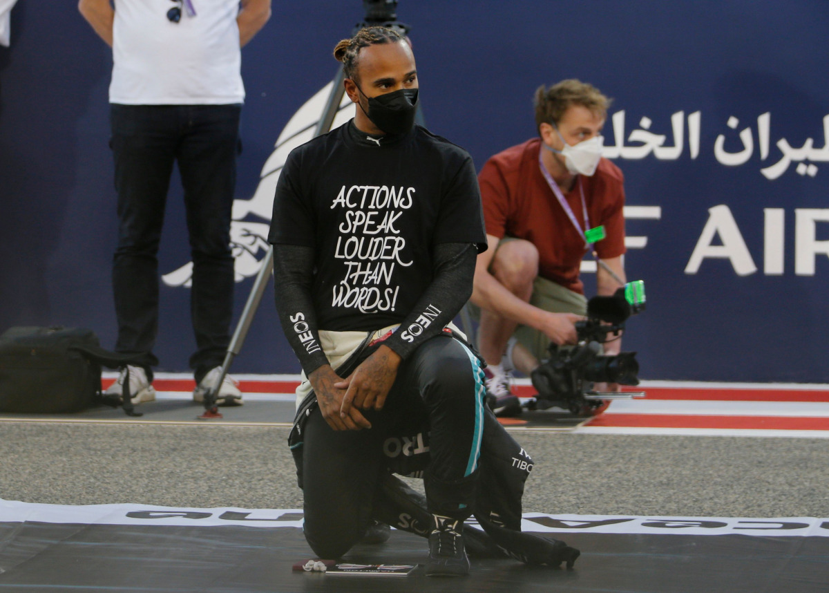 Formula One F1 - Bahrain Grand Prix - Bahrain International Circuit, Sakhir, Bahrain - March 28, 2021 Mercedes' Lewis Hamilton kneels in support of the Black Lives Matter campaign on the grid before the race REUTERS/Hamad I Mohammed

