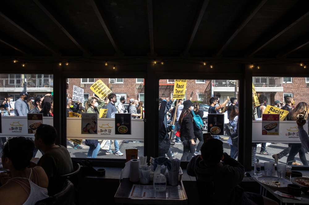 People participate during a national day of action to combat anti-Asian violence in Queens, New York, U.S., March 27, 2021. REUTERS/Jeenah Moon