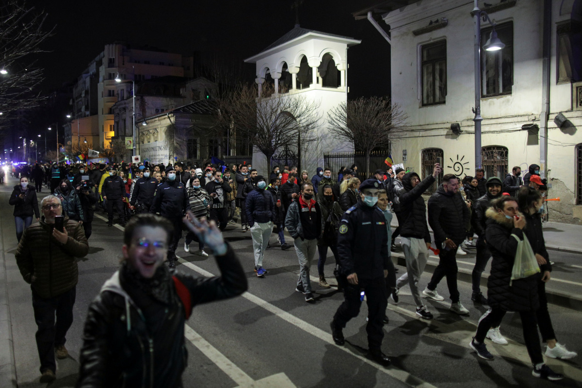 People march demanding an end to COVID-19 restrictions, in Bucharest, Romania, March 30, 2021. Inquam Photos/Octav Ganea via REUTERS
