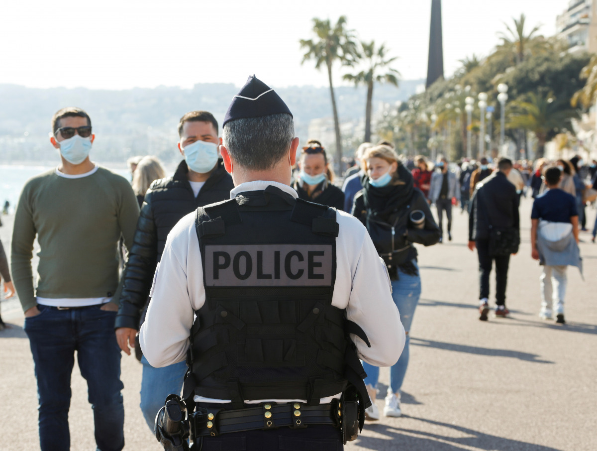 FILE PHOTO: A french police officer patrols on the Promenade des Anglais during the third lockdown imposed to slow the rate of the coronavirus disease (COVID-19) contagion, in Nice, France, March 27, 2021. REUTERS/ Eric Gaillard/File Photo
