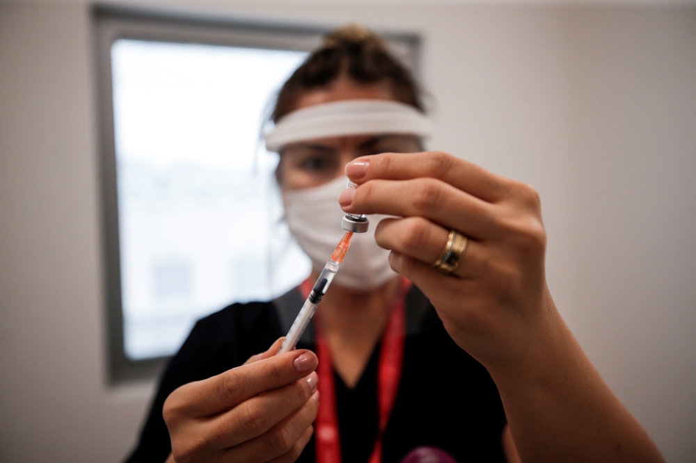 A nurse prepares a dose of the Pfizer-BioNTech coronavirus disease (COVID-19) vaccine at Ankara City Hospital in Ankara, Turkey, April 2, 2021. REUTERS/Cagla Gurdogan