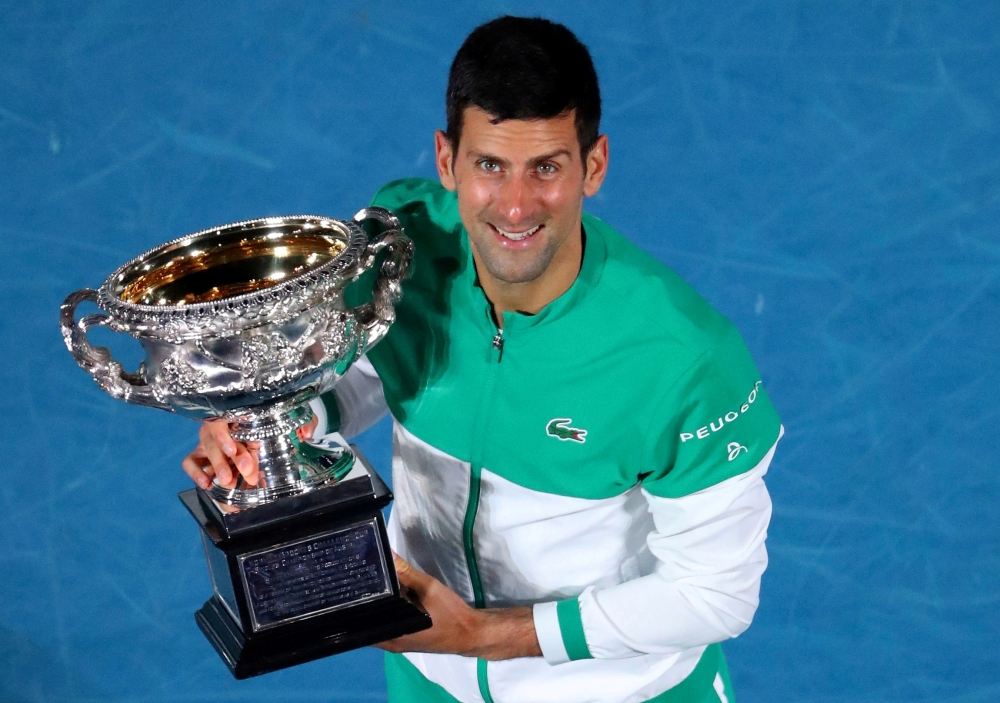Serbia's Novak Djokovic celebrates with the trophy after winning his final match against Russia's Daniil Medvedev REUTERS/Kelly Defina/File Photo
