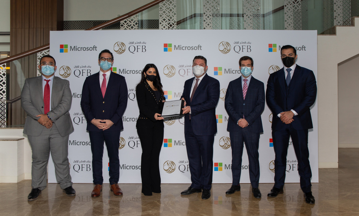Lana Khalaf, Country Manager, Microsoft Qatar and Ayman Zaidan, Deputy Chief Executive Officer & Chief Investment Officer, QFB with other officials during exchange of agreements between Microsoft and QFB on mobile application. 
