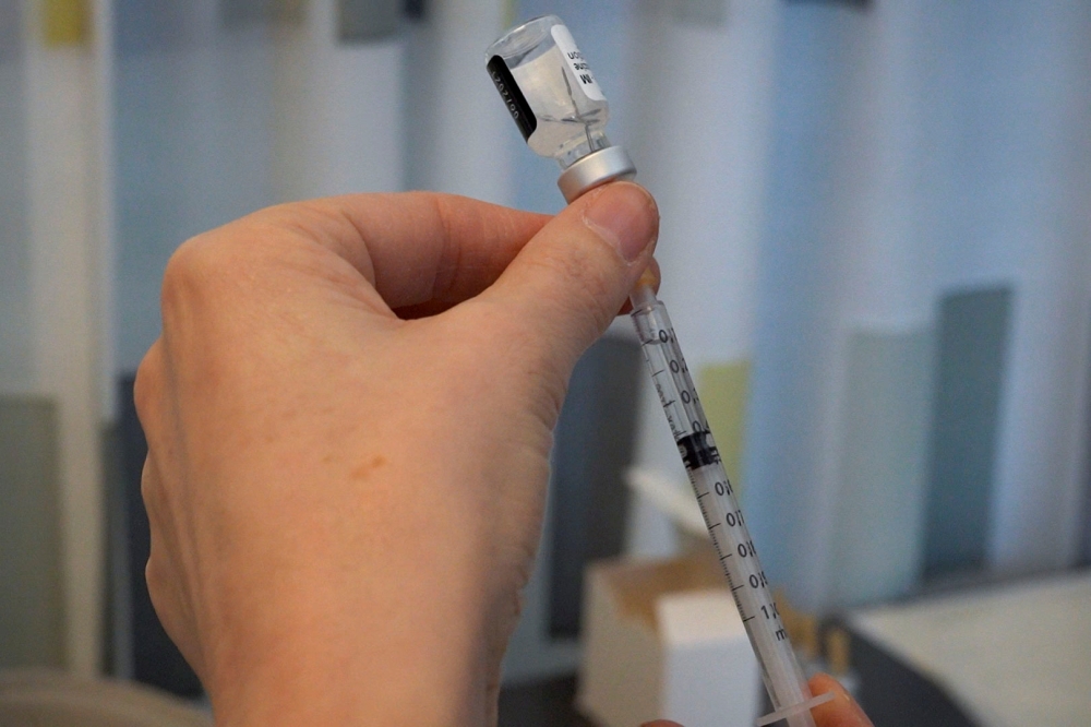 Training nurse Sari Roos prepares a dose of Pfizer/BioNTech vaccine against coronavirus disease (COVID-19) to teach her air bubble technique in Laakso hospital in Helsinki, Finland March 11, 2021. Picture taken March 11, 2021. Reuters/Essi Lehto