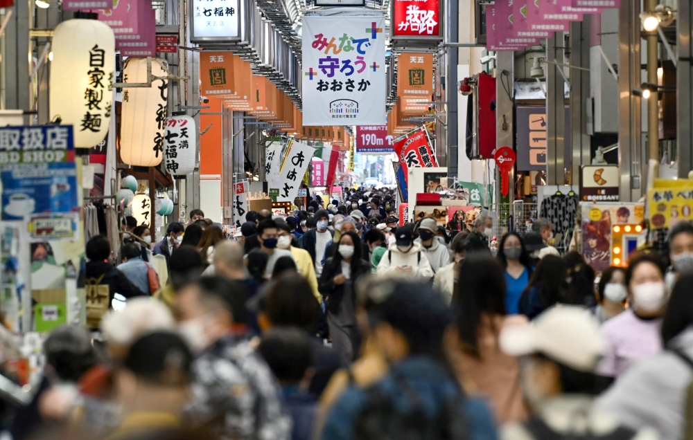 Pedestrians wearing protective face masks, amid the coronavirus disease (COVID-19) pandemic, are seen at a shopping district in Osaka, Japan, in this photo taken by Kyodo April 7, 2021. Mandatory credit Kyodo/via REUTERS