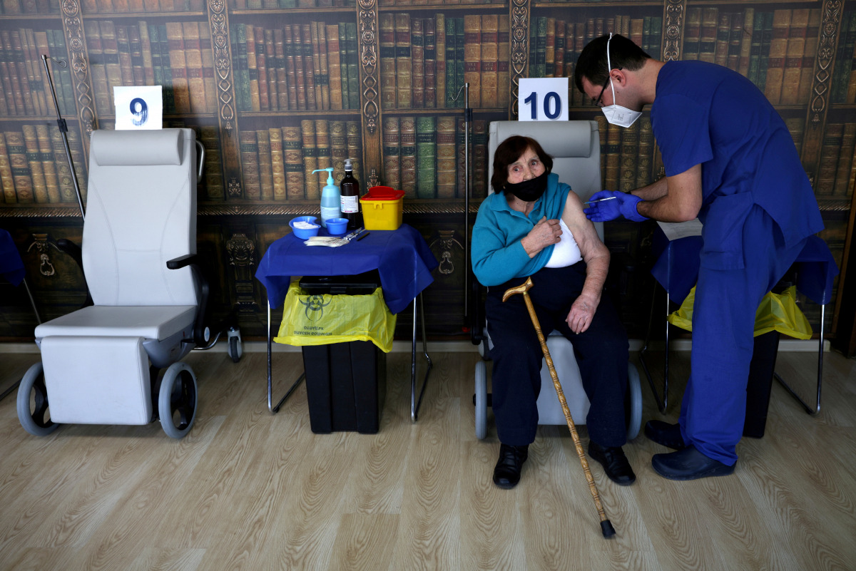 Lala Staribratova, 95, a World War II veteran receives a coronavirus disease (COVID-19) vaccine at the Military Medical Academy in Sofia, Bulgaria, February 23, 2021. REUTERS/Stoyan Nenov/
