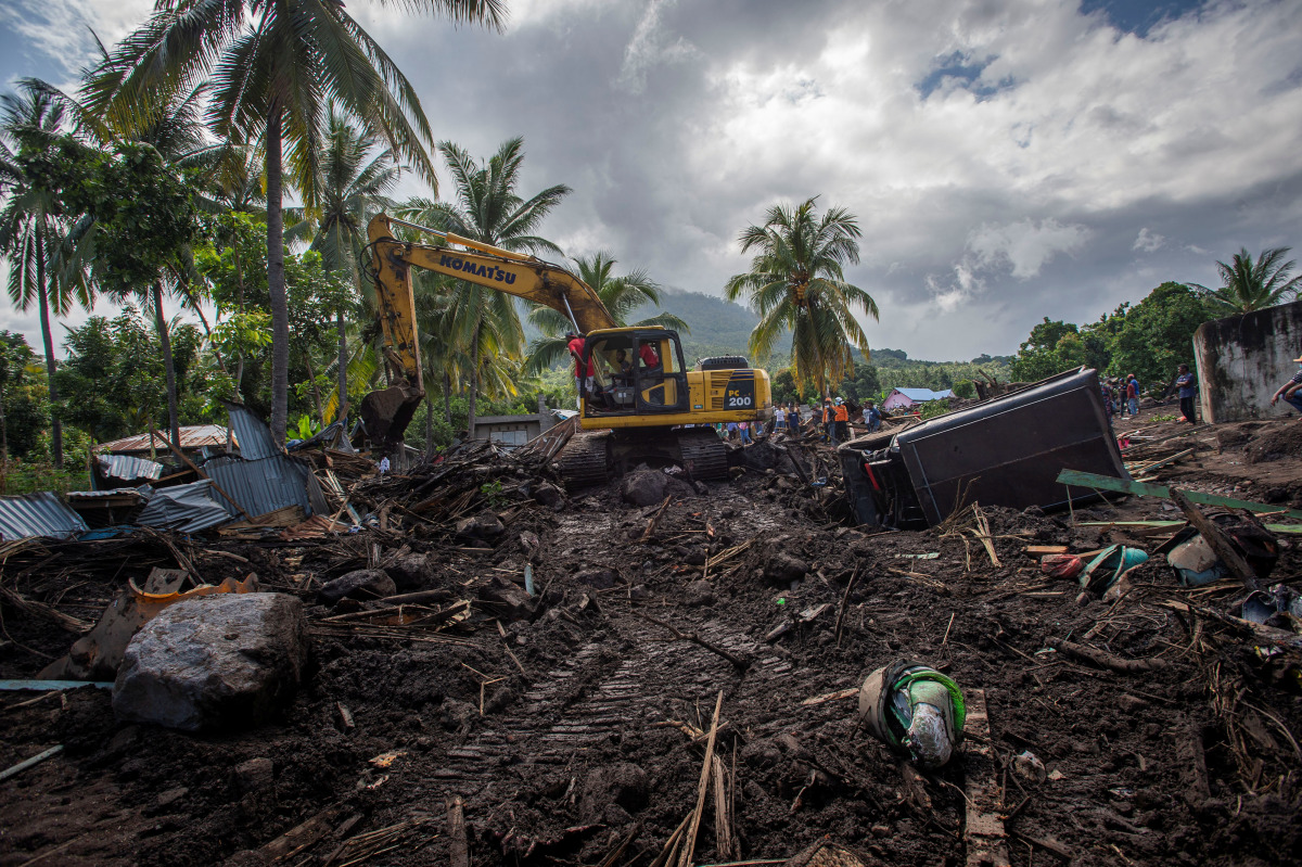 An excavator search for a body at an area affected by landslides triggered by tropical cyclone Seroja in East Flores, East Nusa Tenggara province, Indonesia April 8, 2021, in this photo taken by Antara Foto/Aditya Pradana Putra/via Reuters.