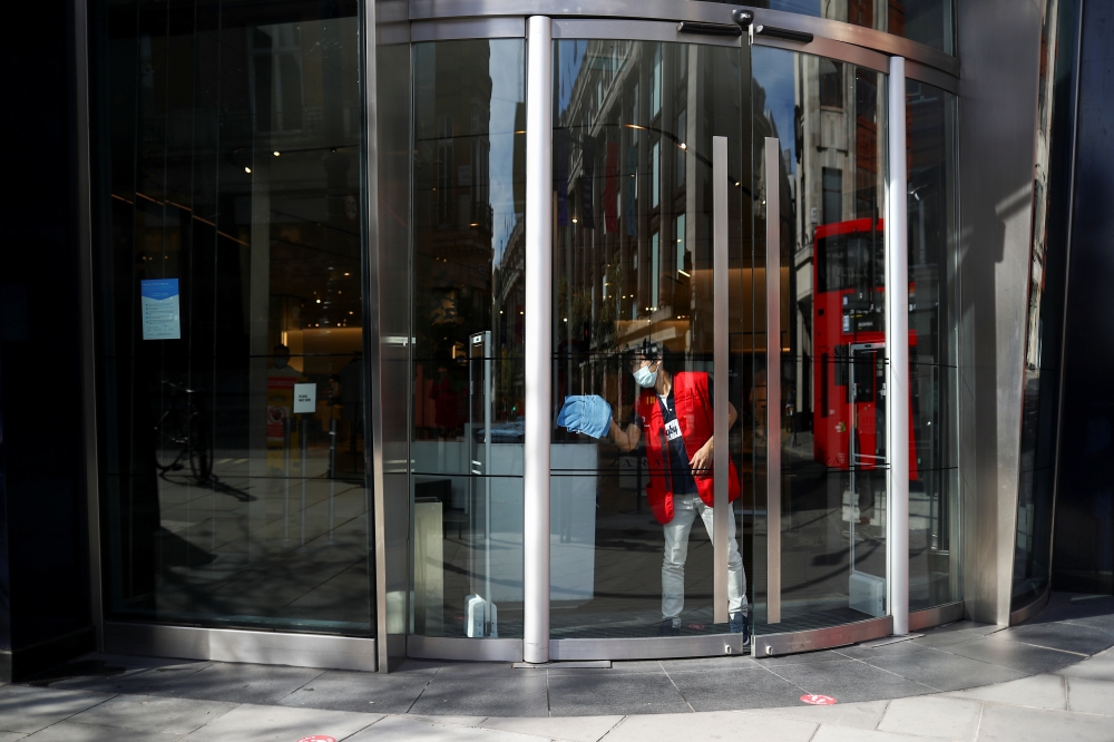 A worker prepares for the reopening of a business, as the coronavirus disease (COVID-19) lockdown restrictions begin to ease, in London, Britain, April 9, 2021. REUTERS/Hannah McKay