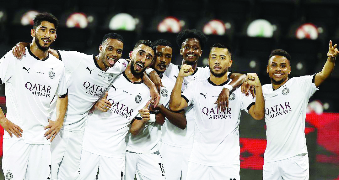 Al Sadd's players celebrate after defeating Qatar SC yesterday to complete an unbeaten season in the QNB Stars League.
