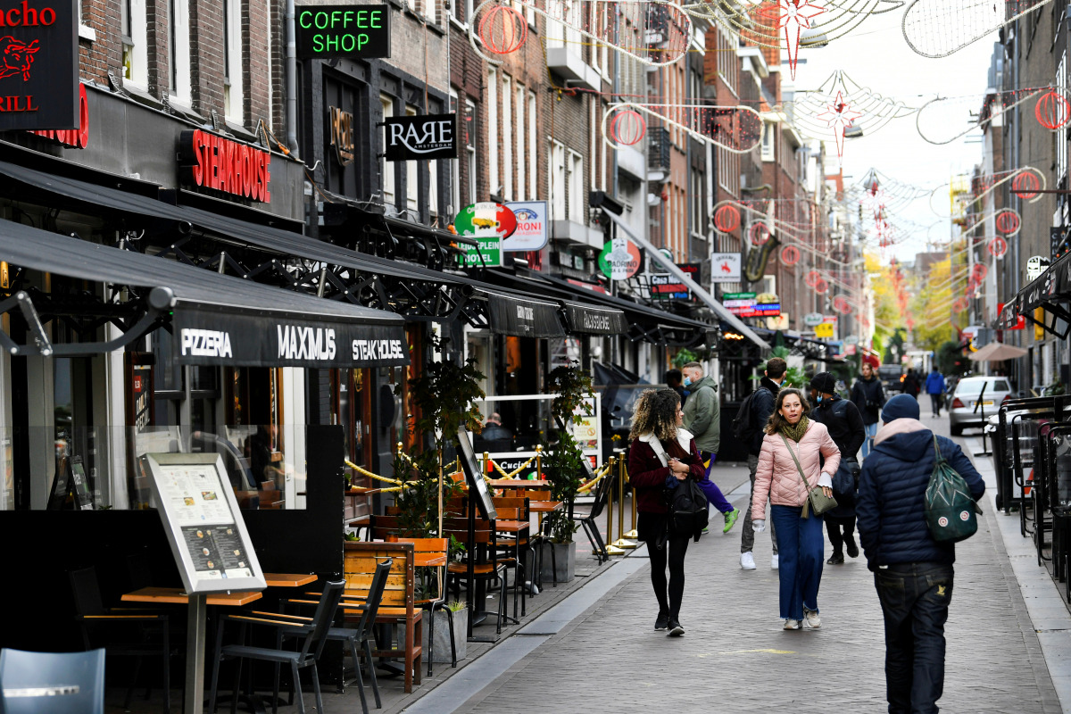 FILE PHOTO: People walk past restaurants following the new social restrictions announced by the Dutch government, as the Netherlands battle to control the spread of the coronavirus disease (COVID-19), in Amsterdam, Netherlands October 14 2020. REUTERS/Pir