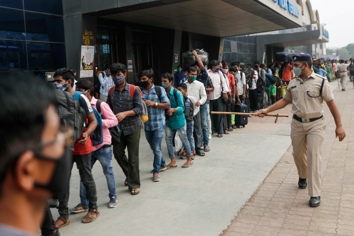 A police officer points at people in line at a railway station amidst the spread of the coronavirus disease (COVID-19) in Mumbai, India, April 11, 2021. REUTERS/Francis Mascarenhas TPX IMAGES OF THE DAY
