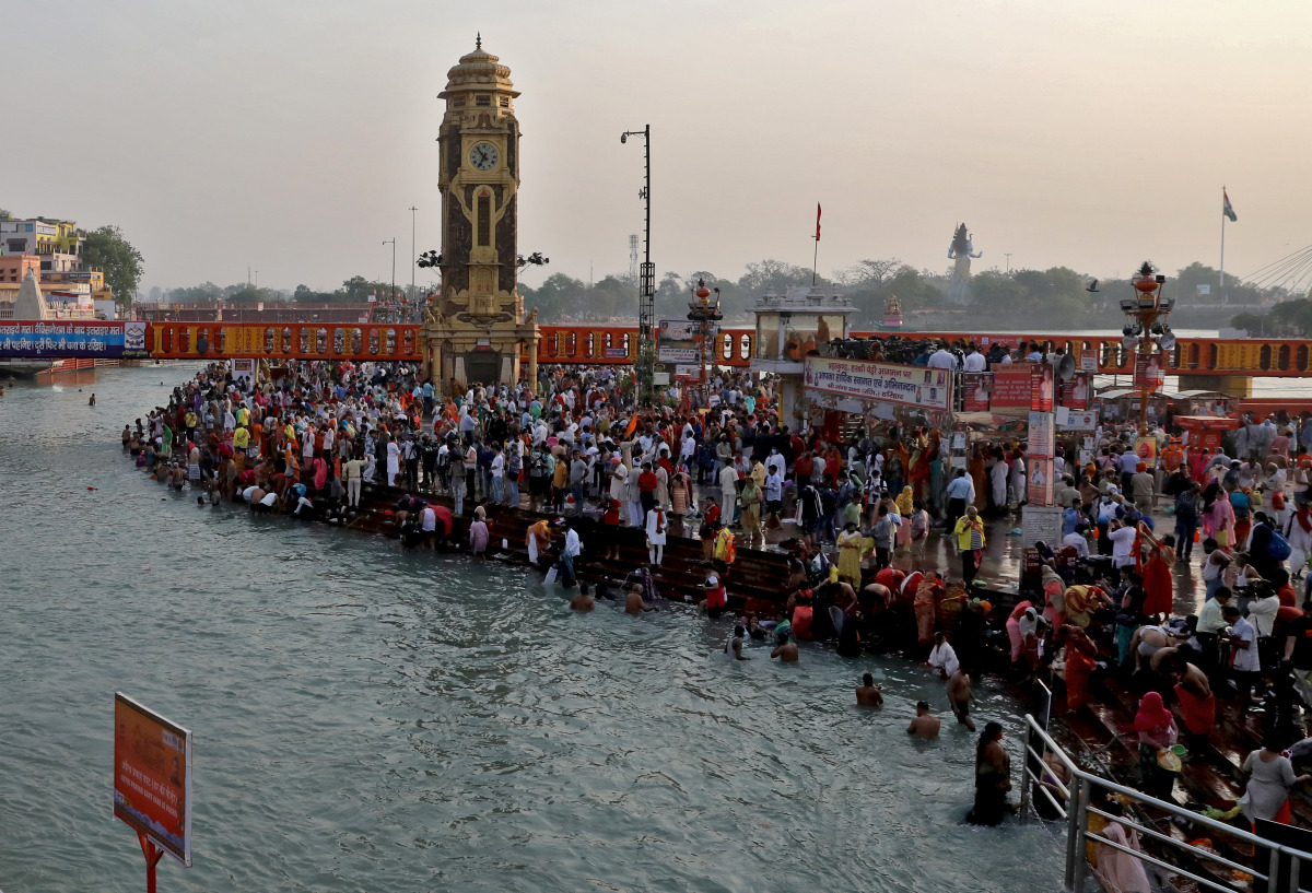 Devotees gather to take a holy dip in the waters of river Ganges during Kumbh Mela, or the Pitcher Festival, amidst the spread of the coronavirus disease (COVID-19), in Haridwar, India, April 12, 2021. REUTERS/Anushree Fadnavis
