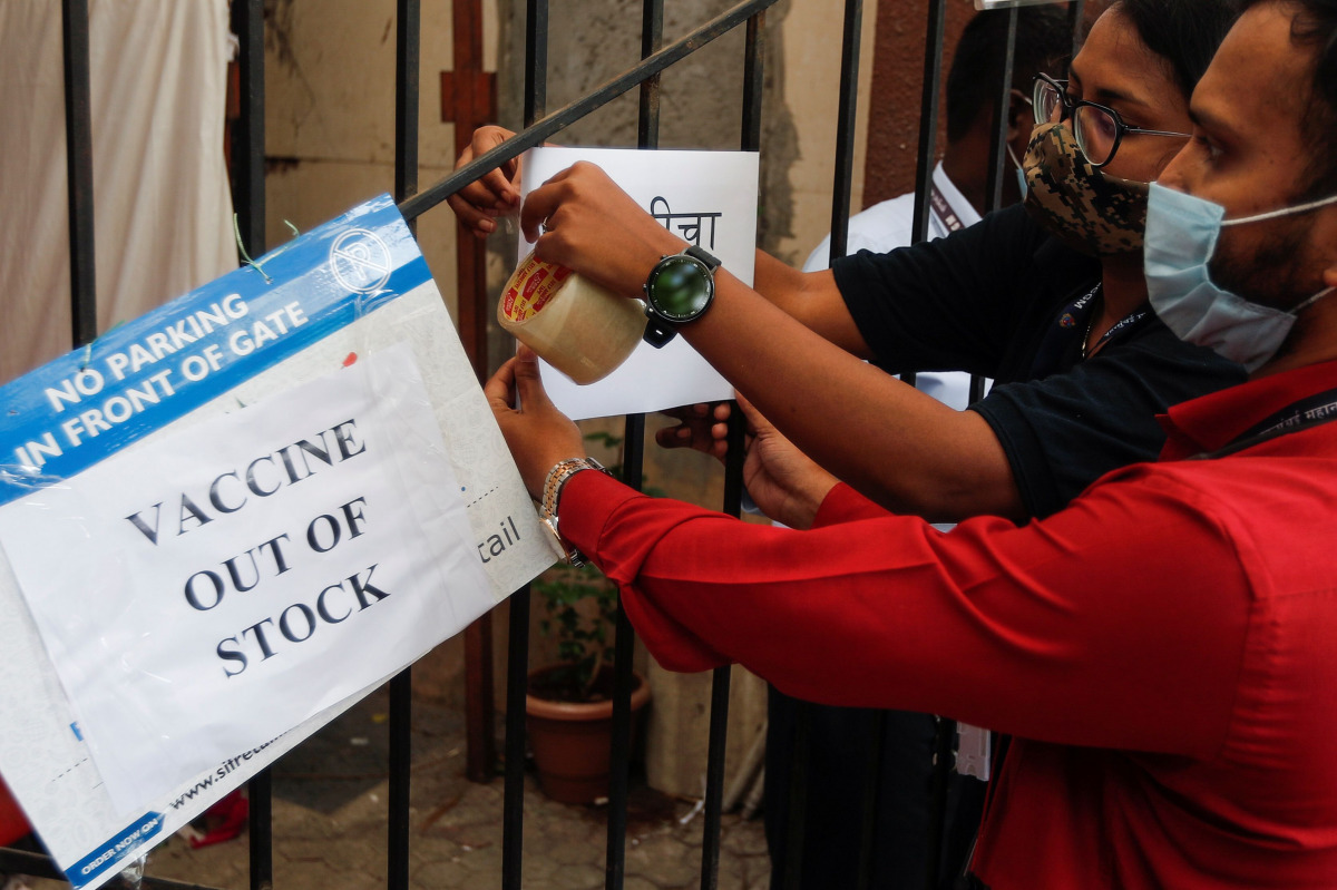 Health workers attach a notice about the shortage of coronavirus disease (COVID-19) vaccine supplies at a vaccination centre in Mumbai, India, April 8, 2021. REUTERS/Francis Mascarenhas
