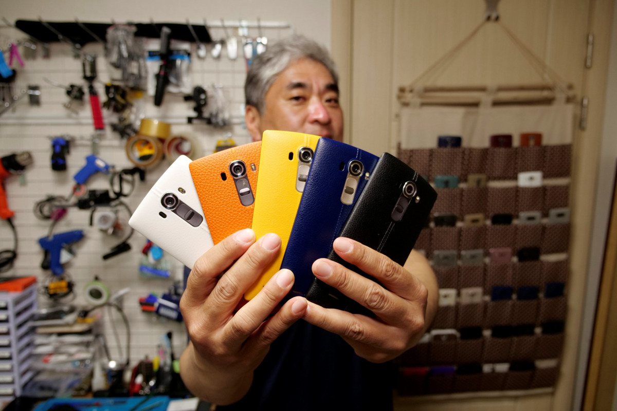 Ryu Hyun-soo, 53, holds his LG smartphones in Anyang, South Korea April 12, 2021. Picture taken April 12, 2021. REUTERS/Daewoung Kim

