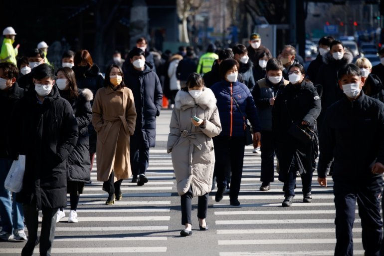 Commuters cross a zebra crossing, amid the coronavirus disease (COVID-19) pandemic in Seoul, South Korea, February 3, 2021. REUTERS/Kim Hong-Ji

