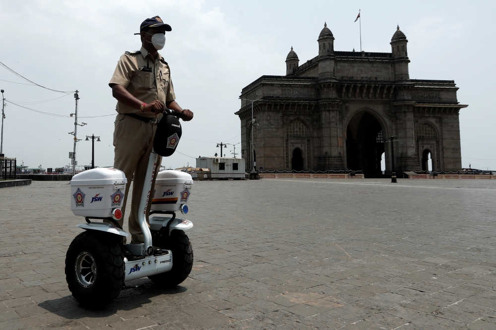 A police officer patrols on a Segway along the promenade outside the Gateway of India during a curfew to limit the spread of the coronavirus disease (COVID-19) in Mumbai, India, April 10, 2021. REUTERS/Francis Mascarenhas
