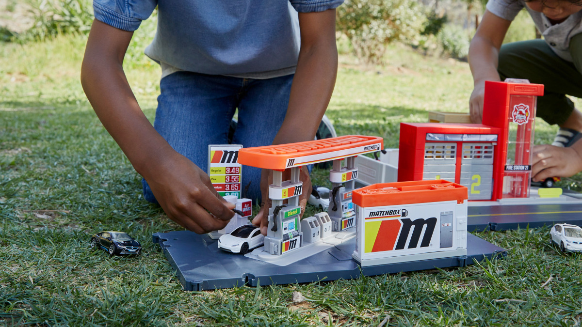 Children play with die-cast cars in this undated photo obtained by Reuters on April 14, 2021. Mattel/Handout via REUTERS