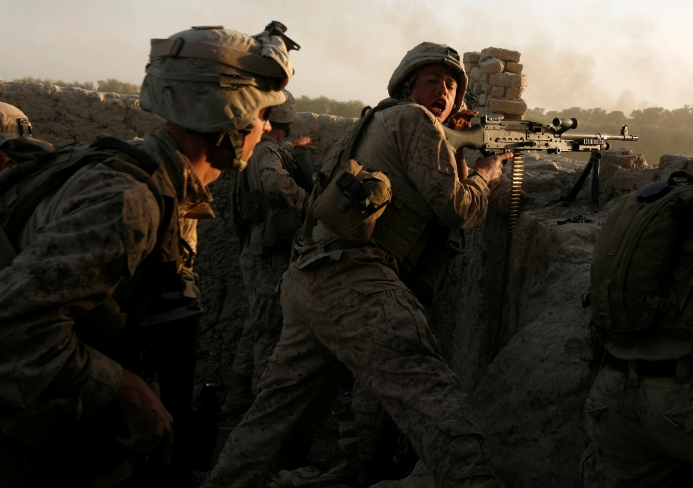File photo: US Marines fire during a Taliban ambush as they carry out an operation to clear an area in Helmand province, Afghanistan, October 9, 2009. Reuters/Asmaa Waguih/File Photo