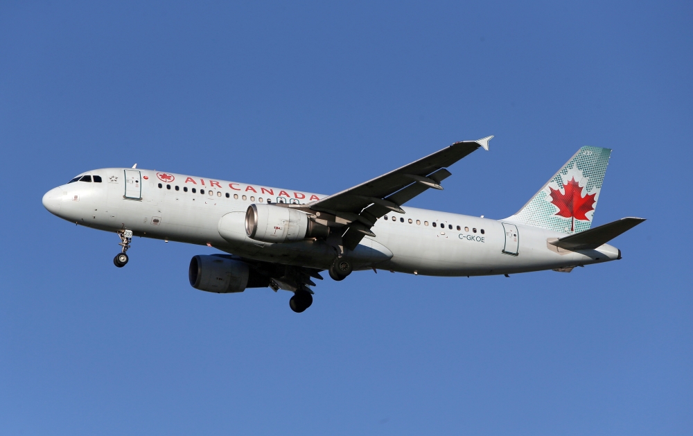 FILE PHOTO: FILE PHOTO: An Air Canada Airbus A320-200 airplane prepares to land at Vancouver's international airport in Richmond, British Columbia, Canada, February 5, 2019. REUTERS/Ben Nelms/File Photo