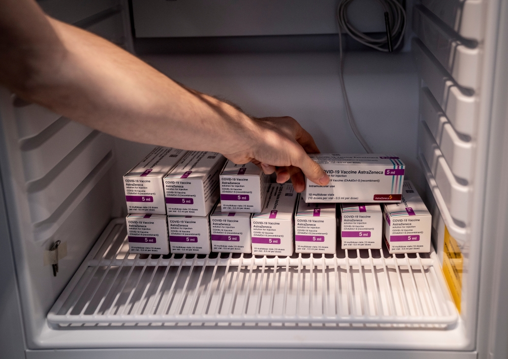 File photo: Staff member handles AstraZeneca COVID-19 vaccines in storage at Region Hovedstaden's Vaccine Center, Copenhagen, Denmark February 11, 2021. Ritzau Scanpix/Liselotte Sabroe via Reuters 