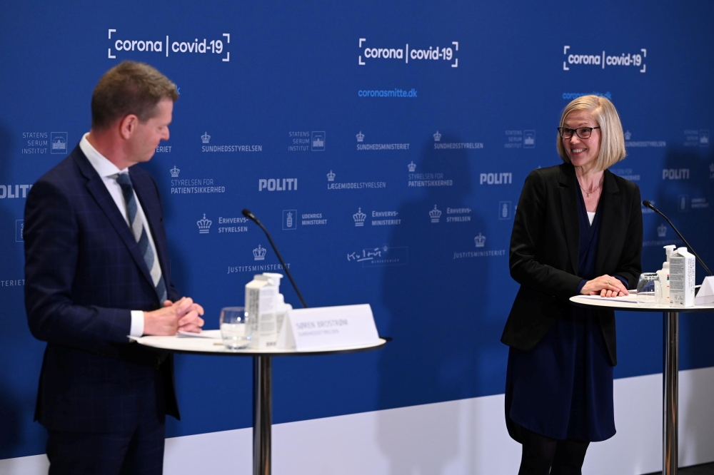 Tanja Erichsen of the Danish Medicines Agency (R) and Director of the National Board of Health, Soeren Brostroem explain why the AstraZeneca vaccine is stopped in Denmark during a press briefing in Copenhagen, Denmark, April 14, 2021. Philip Davali/Ritzau