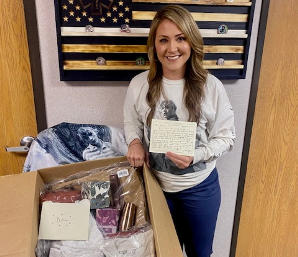 Britta Thomason, flight nurse and programme director, Air Evac Lifeteam, Dublin poses with her box of gifts and handwritten letter from U.S. artist Taylor Swift in her office in Dublin, Georgia, U.S. April 13, 2021. Stuart Crews via REUTERS