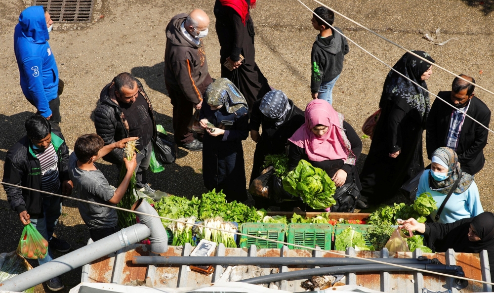 People shop for vegetables at a souk in Beirut, Lebanon April 12, 2021. Picture taken April 12, 2021. REUTERS/Issam Abdallah