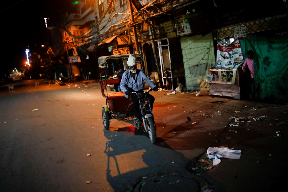 File photo: A man rides a rickshaw on a deserted street during a curfew to limit the spread of the coronavirus disease (COVID-19), in New Delhi, India, April 6, 2021. Reuters/Adnan Abidi/File Photo