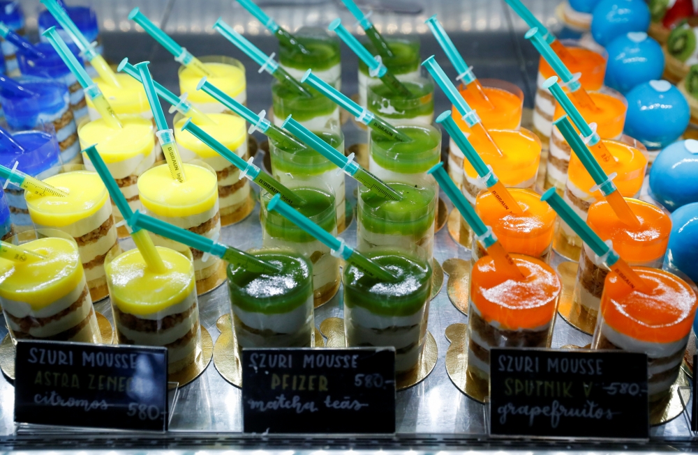 Covid-19 vaccine themed desserts are seen in a cake shop in Veresegyhaz, Hungary, April 16, 2021. Picture taken April 16, 2021. REUTERS/Bernadett Szabo