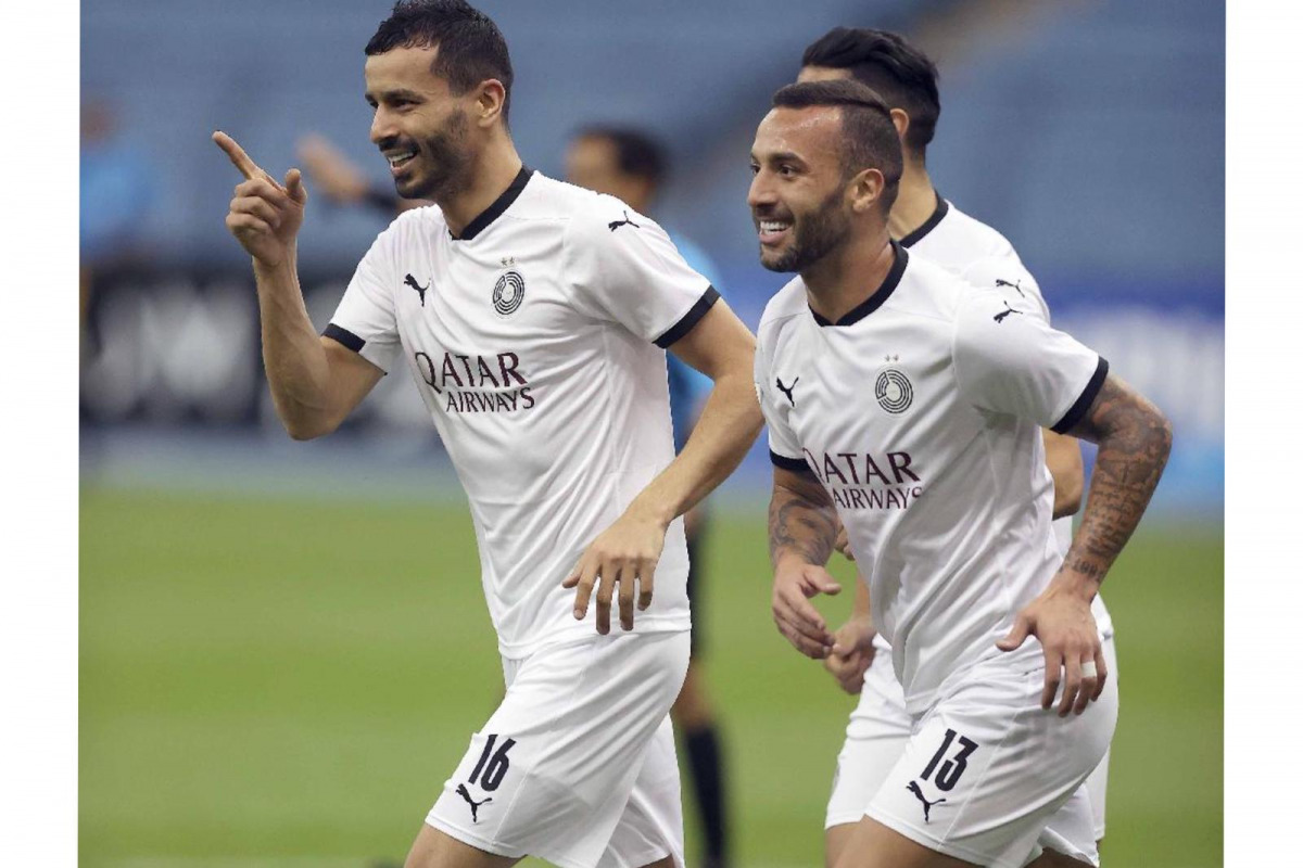 Al Sadd's Boualem Khoukhi celebrates with team-mate Guilherme after scoring their second goal yesterday