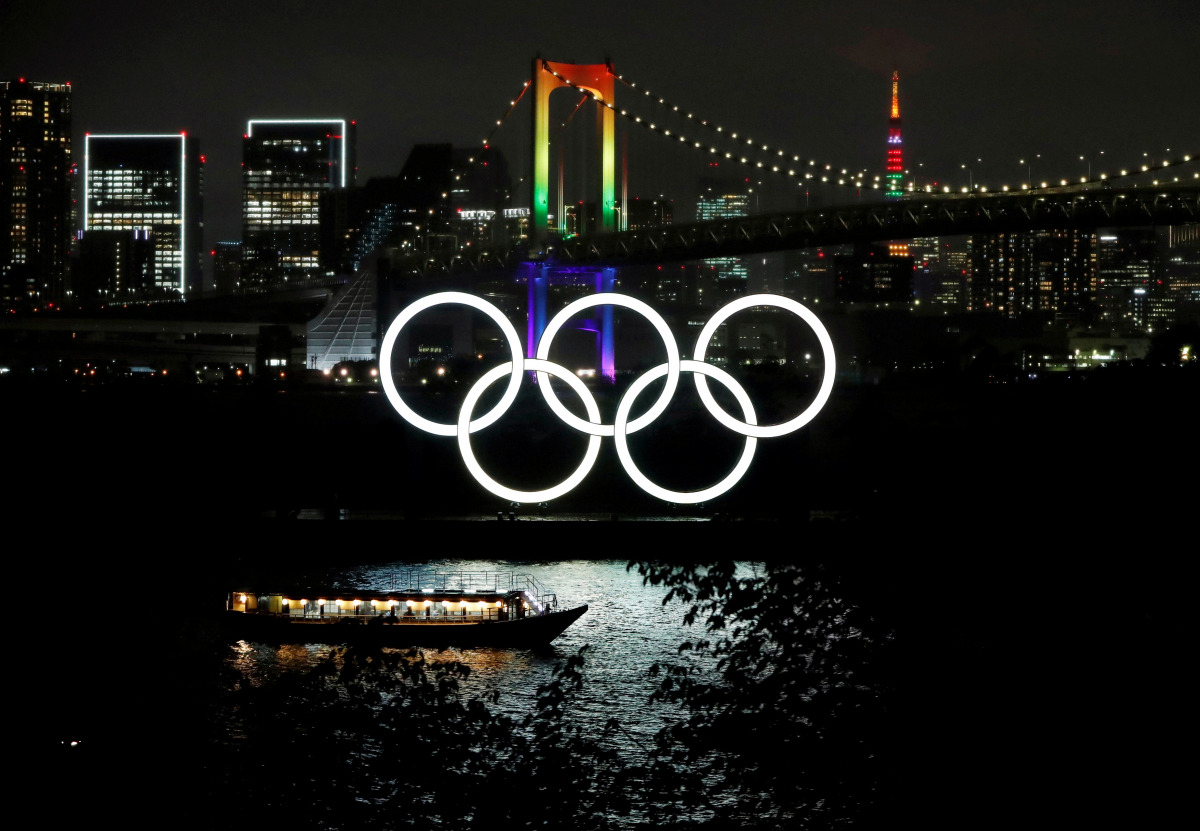 FILE PHOTO: The Rainbow Bridge and Tokyo Tower are illuminated with Olympic colours to mark 100 days countdown to the Tokyo 2020 Olympics that have been postponed to 2021 due to the coronavirus disease (COVID-19) outbreak, in Tokyo, Japan April 14, 2021. 