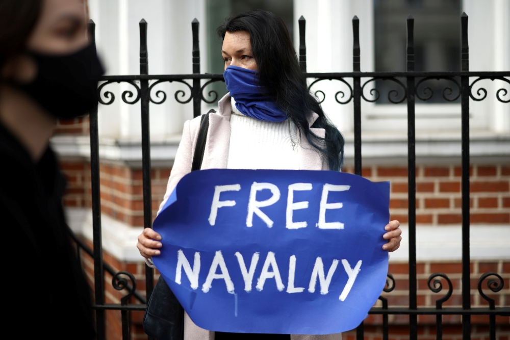 File photo: A woman holds a sign as she takes part in a demonstration in support of jailed Russian opposition politician Alexei Navalny outside the Russian Embassy in London, Britain, April 21, 2021. Reuters/Henry Nicholls/File Photo