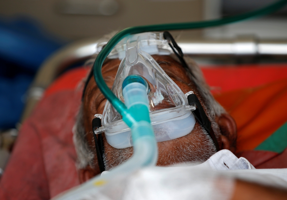 A patient wearing an oxygen mask is seen inside an ambulance waiting to enter a COVID-19 hospital for treatment, amidst the spread of the coronavirus disease (COVID-19) in Ahmedabad, India, April 25, 2021. Reuters/Amit Dave