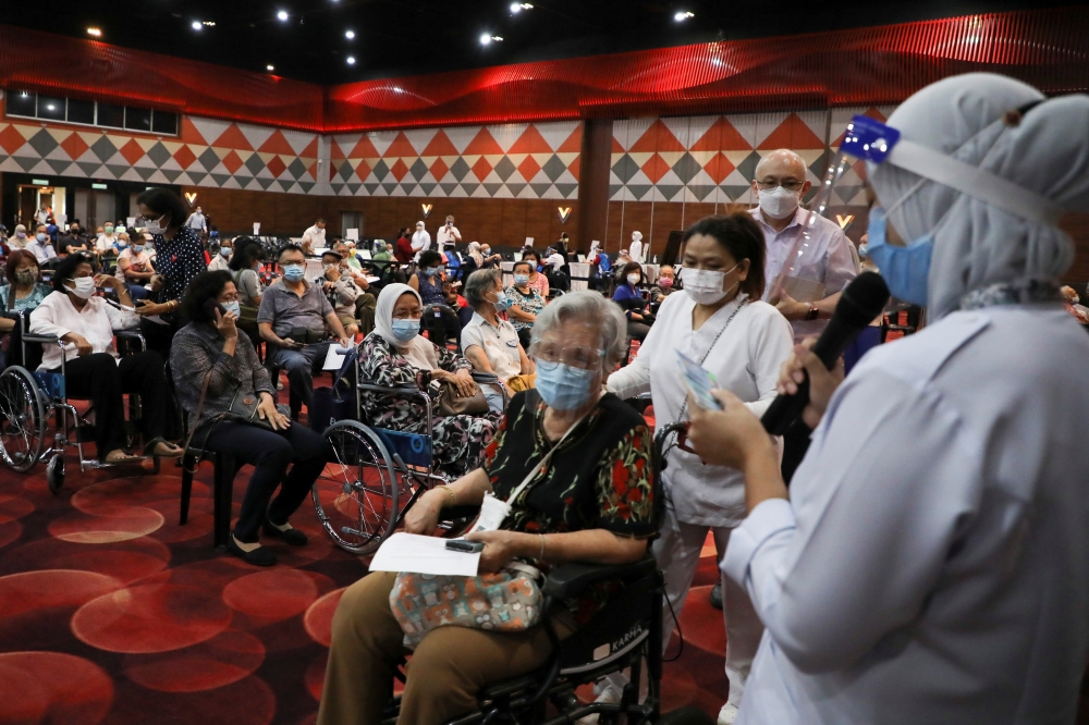 People wait to receive a vaccine for the coronavirus disease (Covid-19) at a vaccination centre in Subang Jaya, Malaysia April 26, 2021. Reuters/Lim Huey Teng
 