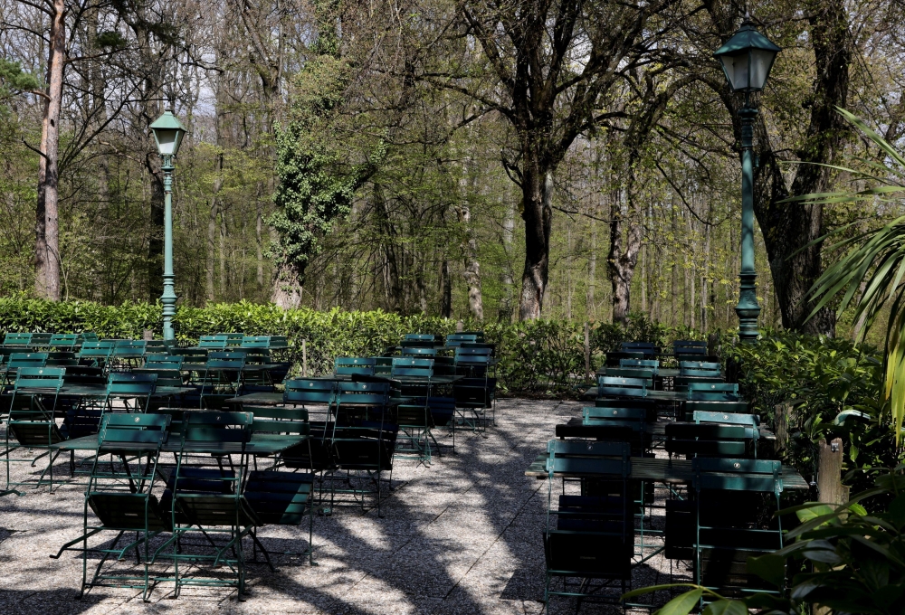 Tables and chairs are pictured next to a closed restaurant as the coronavirus disease (COVID-19) lockdown continues in Vienna, Austria April 23, 2021. REUTERS/Leonhard Foeger/File Photo
