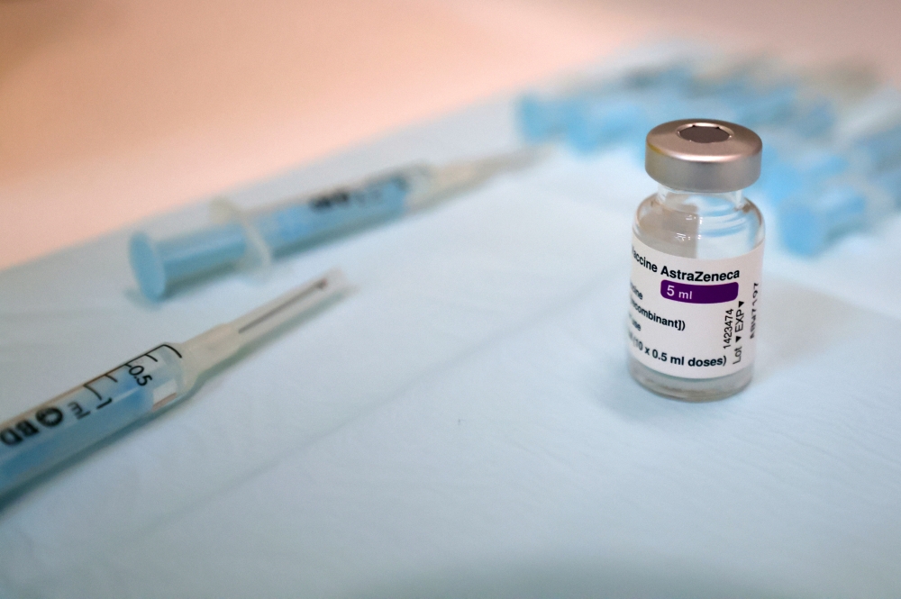 Needles and a vial of AstraZeneca's vaccine against coronavirus disease (COVID-19) are pictured during a pilot test which aims to apply 20,000 vaccines per day in coming months, at Fira de Montjuic in Barcelona, Spain, April 26, 2021. REUTERS/Nacho Doce