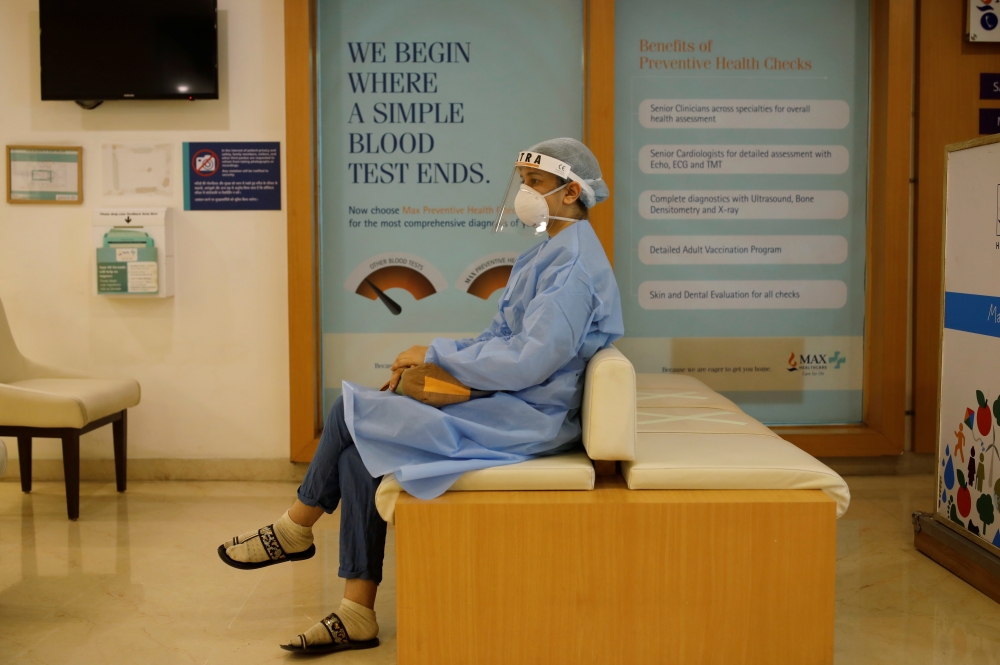 A woman waits to be vaccinated for the coronavirus disease (COVID-19) at a hospital, in New Delhi, India, May 1, 2021. Reuters/Adnan Abidi