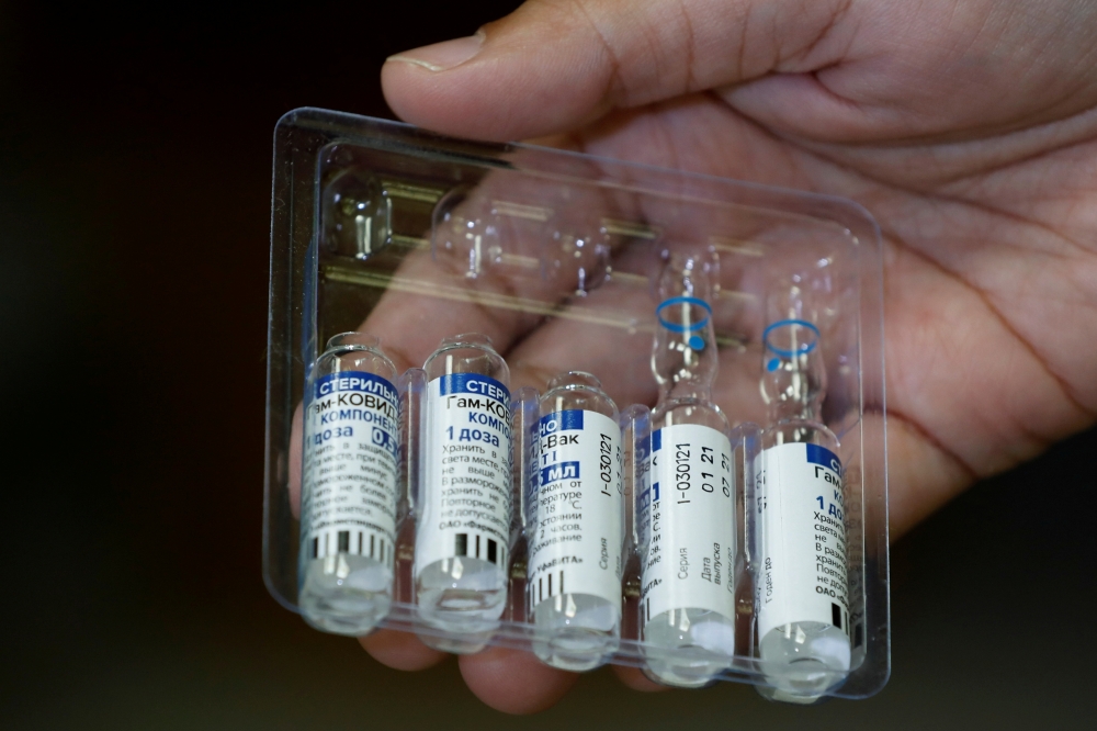 FILE PHOTO: A paramedic holds a pack of used and unused vials of Russia's Sputnik V coronavirus disease (COVID-19) vaccine at a private hospital in Karachi, Pakistan April 4, 2021. REUTERS/Akhtar Soomro