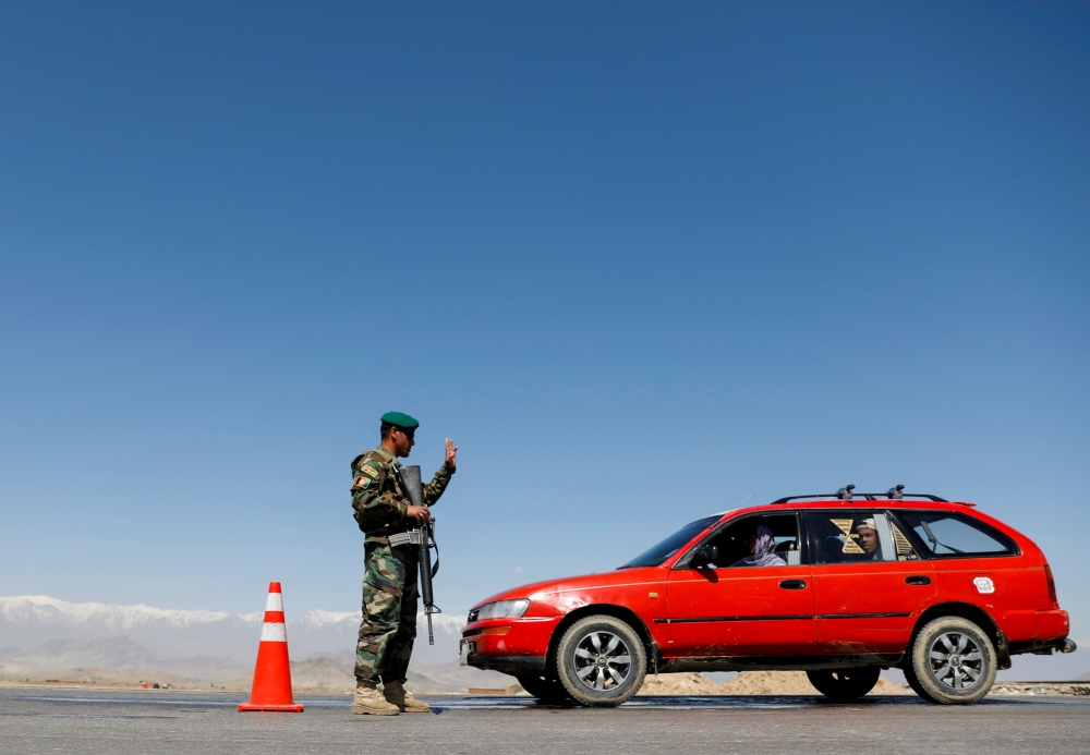 FILE PHOTO: An Afghan National Army soldier stands guard at a checkpoint on the outskirts of Kabul, Afghanistan April 21, 2021. REUTERS/Mohammad Ismail/File Photo