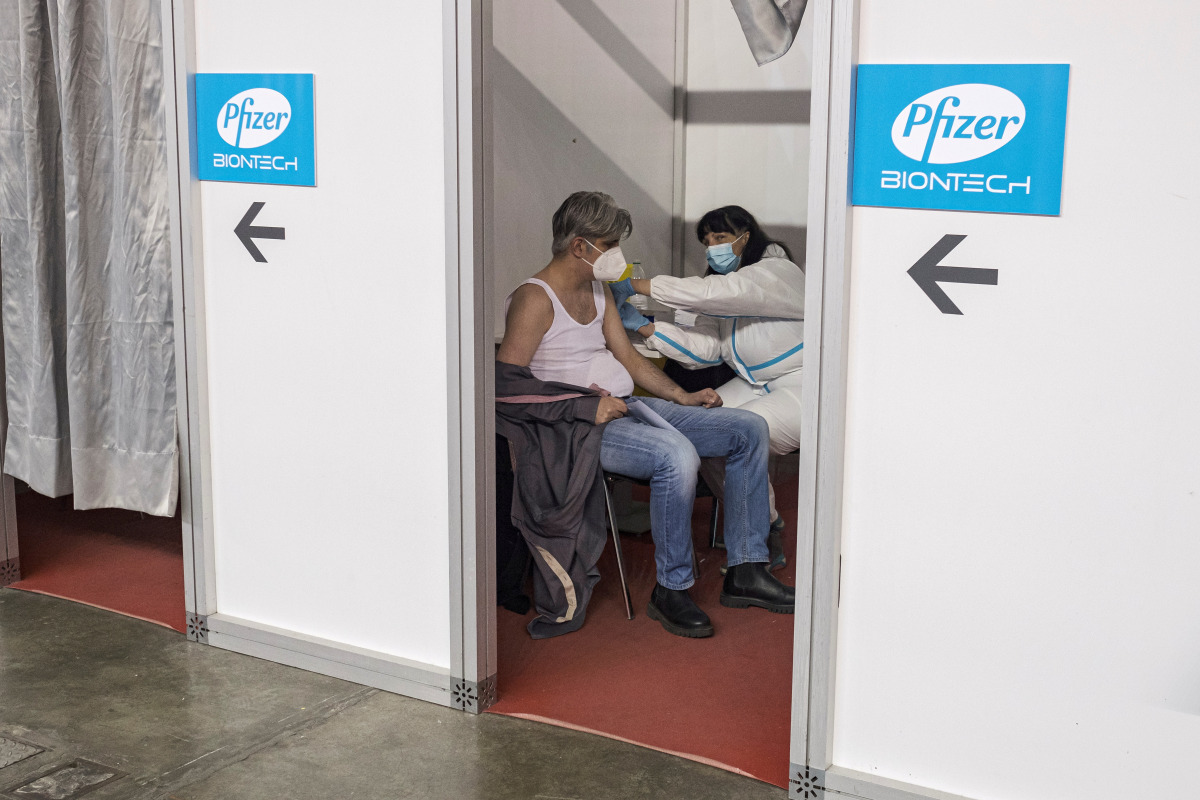 FILE PHOTO: A man receives a second dose of the Pfizer-BioNTech vaccine against the coronavirus disease (COVID-19) at the hall three of the Belgrade Fair, in Belgrade, Serbia, April 13, 2021. REUTERS/Marko Djurica/File Photo
