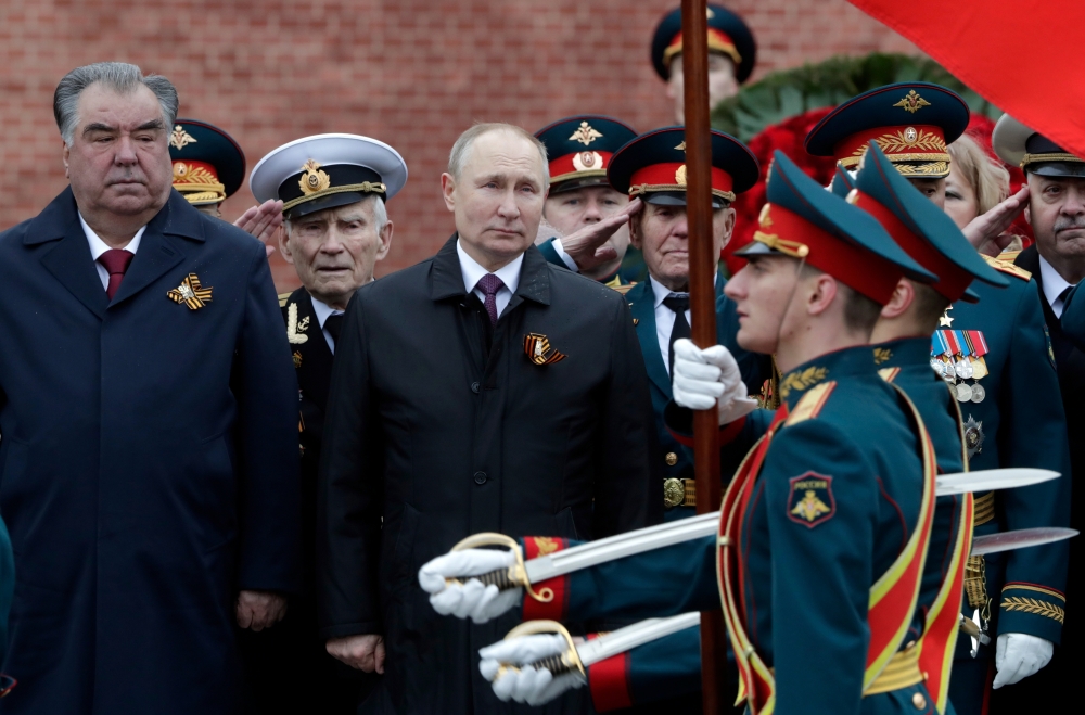 Russian President Vladimir Putin and Tajik President Emomali Rakhmon watch honour guards passing by during a commemoration ceremony at the Tomb of the Unknown Soldier on Victory Day, which marks the 76th anniversary of the victory over Nazi Germany in Wor