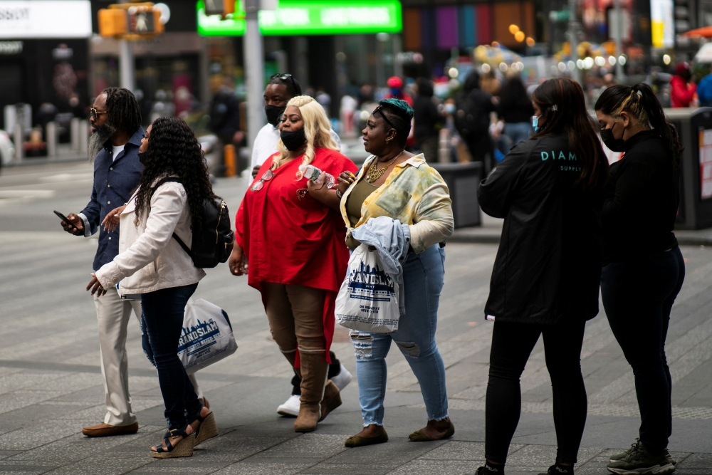 People make their way at Times Square, amid the coronavirus disease (COVID-19) pandemic, in Manhattan, New York City, U.S., May 7, 2021. REUTERS/Eduardo Munoz