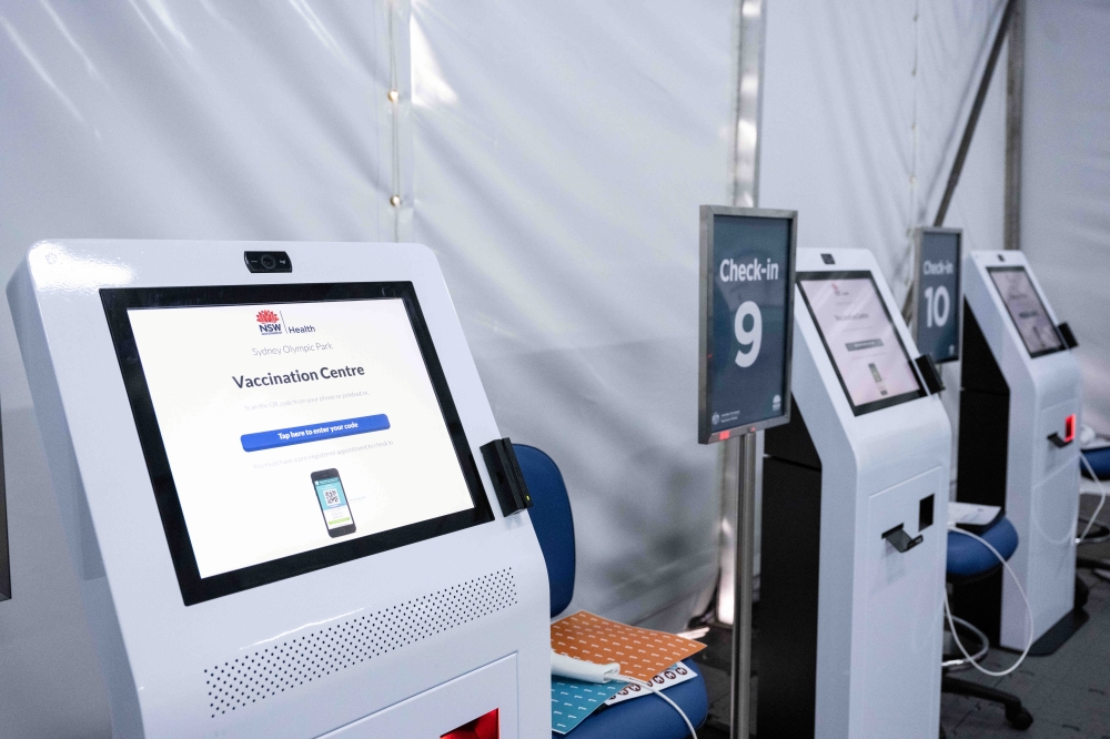 Check-in machines are seen at the arrivals area of a New South Wales coronavirus disease (COVID-19) mass vaccination hub as it opens at Sydney Olympic Park in Sydney, Australia, May 10, 2021. James Gourley/Pool via Reuters