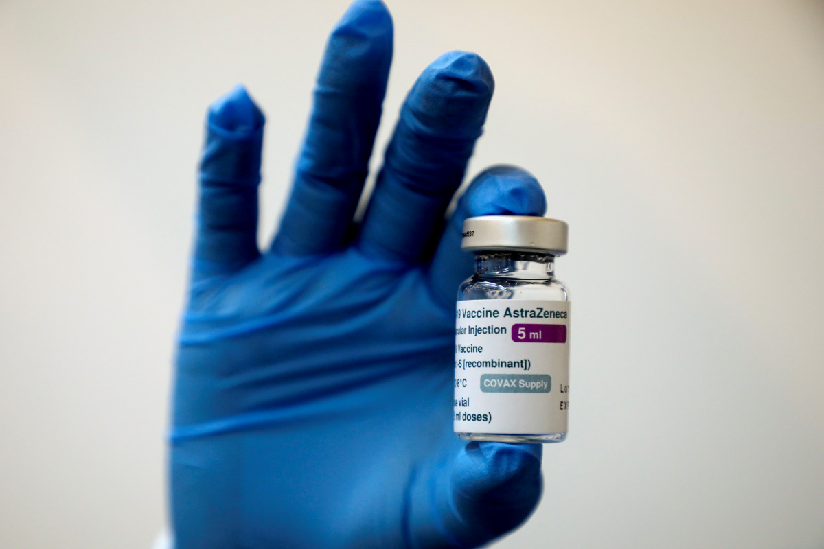 FILE PHOTO: A medical worker holds a bottle of AstraZeneca's COVID-19 vaccine at a vaccination centre in Kuala Lumpur, Malaysia May 5, 2021 in this file photo. REUTERS/Lim Huey Teng/File Photo
